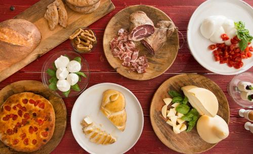 a table with plates of different types of food at Masseria San Giovanni - Epoca Collection in Fasano