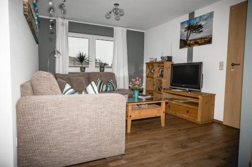 a living room with a couch and a television at Abendsonne in Stralsund