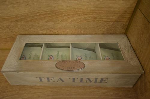 a wooden box filled with books with a coin in it at Villa Aba apartments in Sarajevo