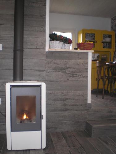 a fireplace in the middle of a living room at A Tasca in Vila Real