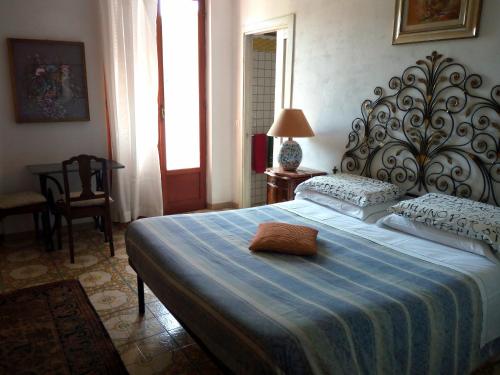 a bedroom with a large bed with a blue blanket at Casa vancanza Sciamandola in Levanto