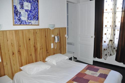 Katil atau katil-katil dalam bilik di Citotel Hôtel Cesar