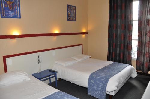 Katil atau katil-katil dalam bilik di Citotel Hôtel Cesar