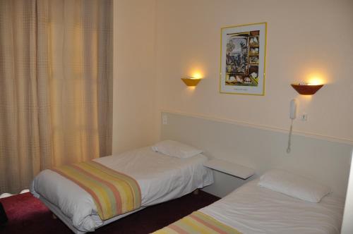 Katil atau katil-katil dalam bilik di Citotel Hôtel Cesar