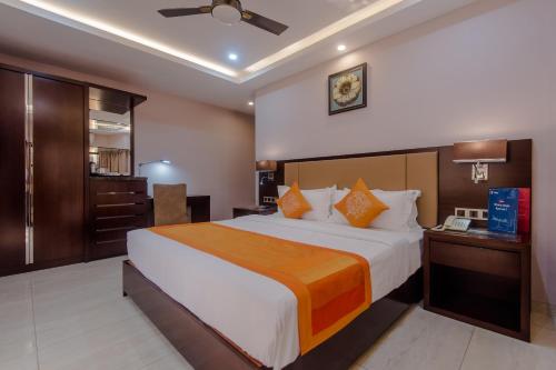 a bedroom with a large bed in a room at Hotel Godwin - Colaba in Mumbai