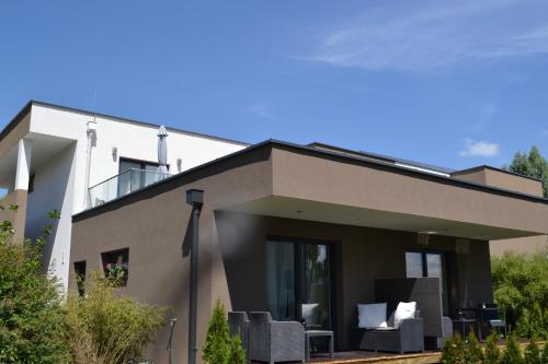 a house with a roof that has a patio at Kal's Studio Apartment Salzburg in Salzburg