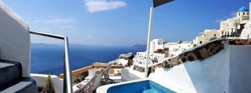 a view of the ocean from a balcony of a house at Aqua & Terra Traditional Cave Houses in Oia