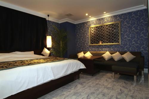 a hotel room with a bed and a desk at Hotel Cuna Kyoto Love Hotel in Kyoto