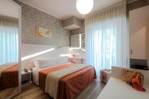 Postel nebo postele na pokoji v ubytování Hotel Ombretta Mare