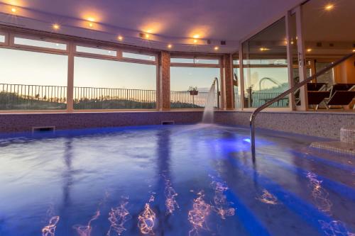 a swimming pool with a fountain in a house at Colleverde Country House & SPA Urbino in Urbino
