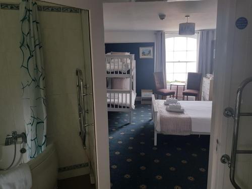 a bathroom with a room with a table and a room with a room at Waterfront Hotel in Deal