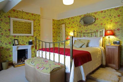 a bedroom with a bed and a fire place at Victoria House in Church Stretton