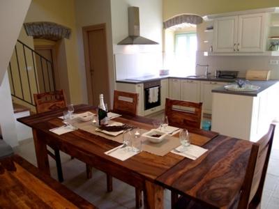 a kitchen with a wooden table with wine glasses on it at Villa Bellevue in Vižinada