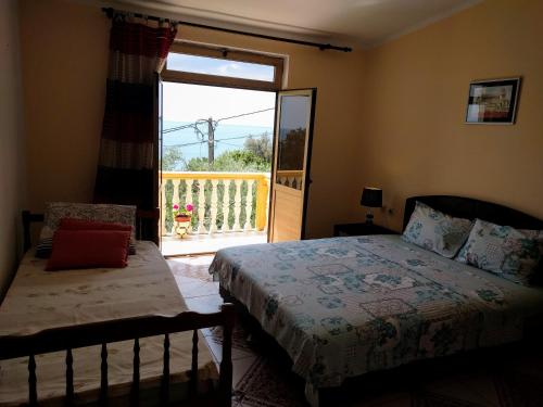 a bedroom with a bed and a door to a balcony at Apartment Spuza in Ulcinj