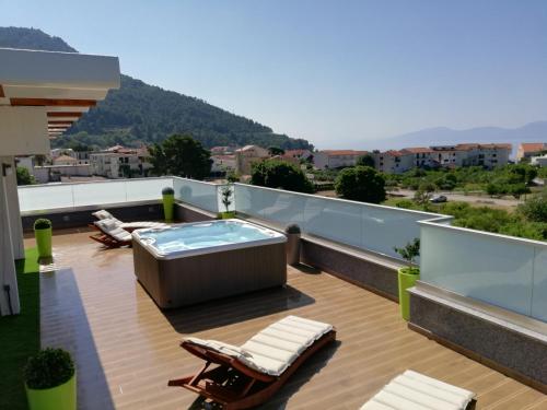 a patio with a hot tub on a roof at Apartments Villa Katija in Drvenik