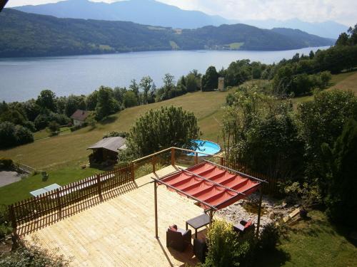a view of a house with a pool and a fence at Apartment Haus Starfach in Döbriach