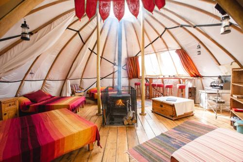 a room with a yurt with a fireplace in it at Larkhill Tipis and Yurts in Carmarthen