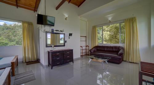 a living room with a couch and a television at Hanthana Villa in Kandy