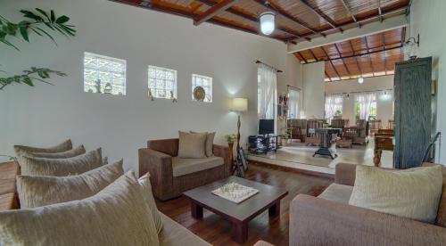 a living room with couches and a coffee table at Hanthana Villa in Kandy