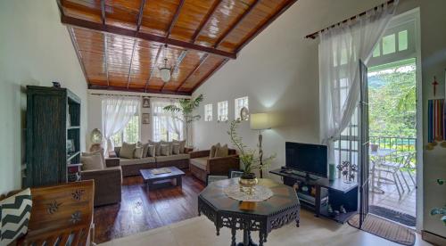 a living room with a couch and a table at Hanthana Villa in Kandy