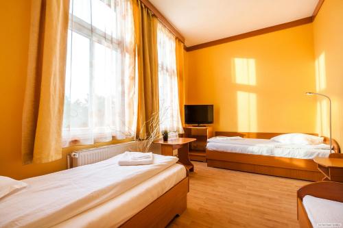 a hotel room with two beds and a window at Szilagyi Hotel&Restaurant in Gheorgheni