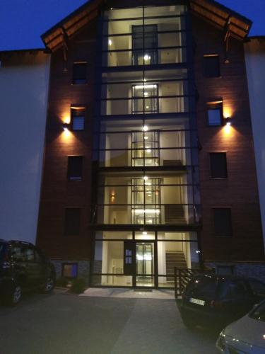 a tall building with lights on in a parking lot at Sweet Dreams SPA in Zlatibor