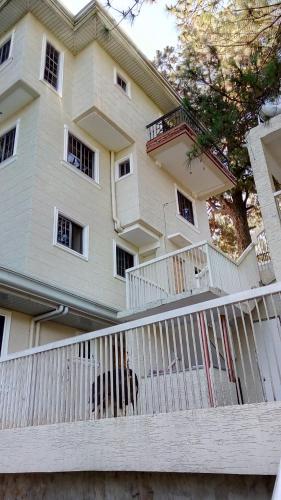 a white fence in front of a building at Koinonia Retreat CenteR in Baguio