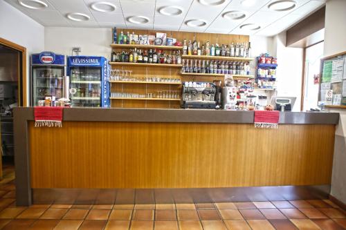 a bar in a restaurant with a wooden counter at Albergo Gusmeroli in Tirano