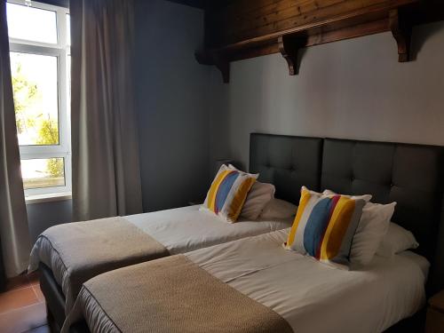 two beds sitting next to each other in a bedroom at Cosy Sintra in Sintra