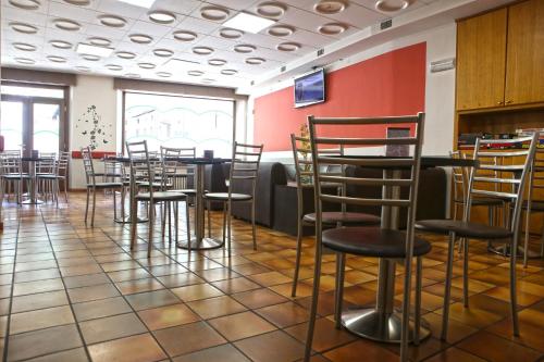 a restaurant with chairs and tables in a room at Albergo Gusmeroli in Tirano
