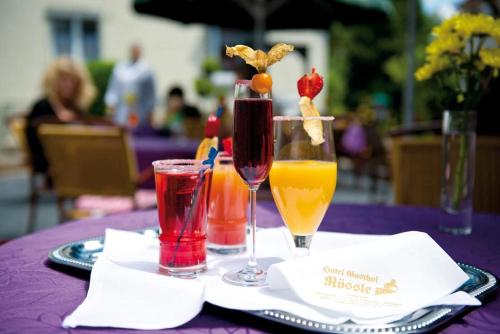 a purple table with two glasses of drinks on it at Hotel Gasthof Rössle in Rottenburg