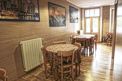 a row of tables and chairs in a restaurant at Albergo Gusmeroli in Tirano