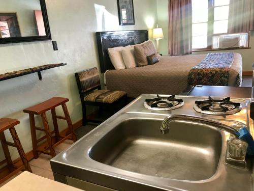 a kitchen with a sink in a hotel room at Caboose Motel & Gift Shop in Durango