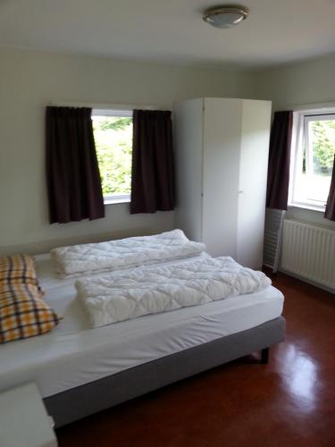 Postel nebo postele na pokoji v ubytování Dunopark Bungalow