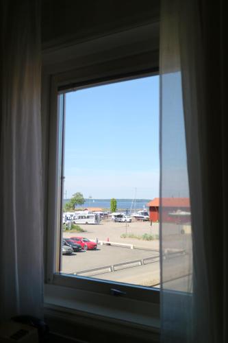 a window with a view of a parking lot at Vänerport Lakefront Hotell in Mariestad