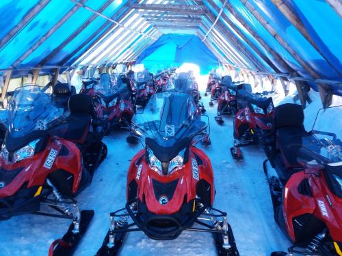 a group of motorcycles parked in a tent at Camp Alta Kiruna in Kiruna