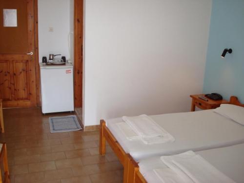 a small kitchen with a white refrigerator and a table at Ethra in Patitiri