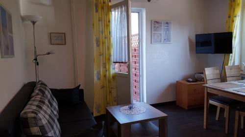 a living room with a couch and a table at Wohnung 3 mit Terrasse Haus Annegrete in Bensersiel