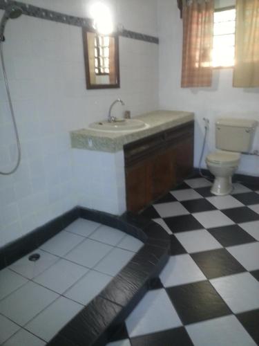 a bathroom with a sink and a toilet at Sunset Villa Eco Friendly House in Kilifi
