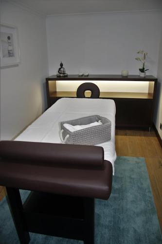 a bedroom with a bed with a black and white mattress at O Casario in Mirandela