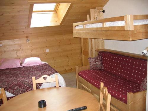 a room with a bed and a couch and a table at Studio Bel'Alp in Le Grand-Bornand