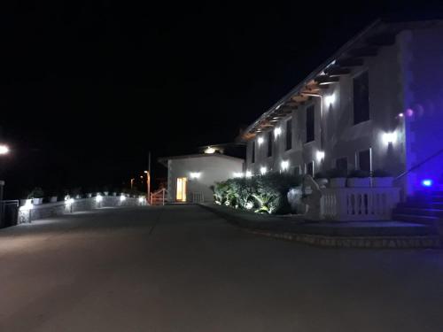 a house with lights on the side of it at night at B&B Villa Catiè in Castellammare di Stabia