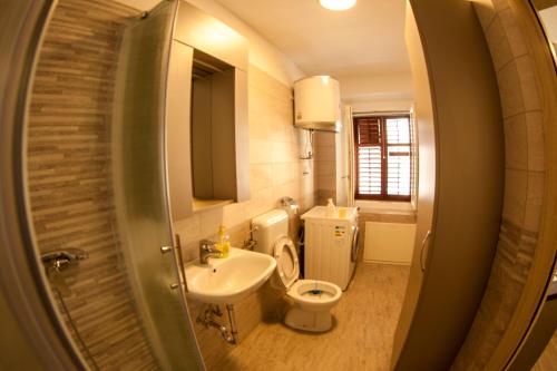 a small bathroom with a toilet and a sink at Port in Izola