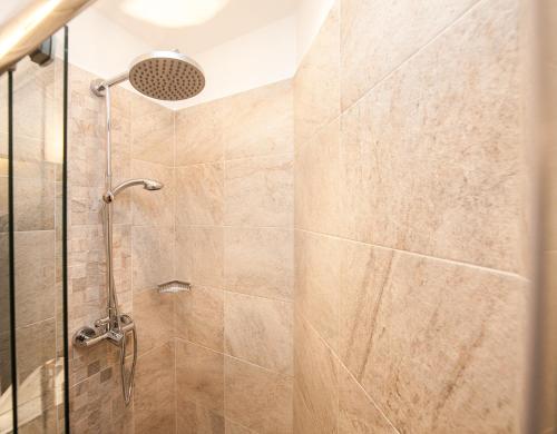 a bathroom with a shower with a glass door at Traditional Apartments Vienna TAV - Entire in Vienna