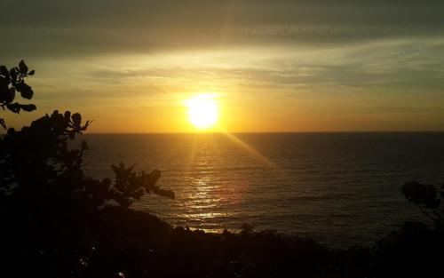 a sunset over the ocean with the sun in the sky at Venice Seaview Hotel in Xiaoliuqiu