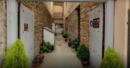an empty hallway with plants in a brick building at Albergue San Lázaro in Sarria