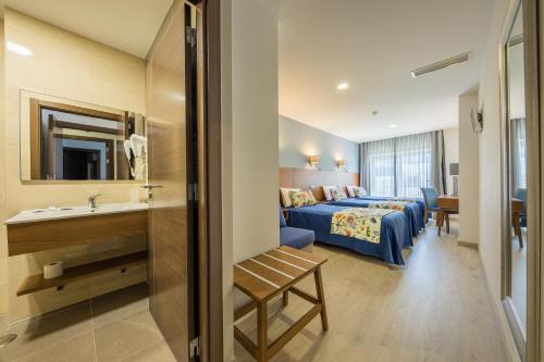 a hotel room with a bed and a sink at Hotel Santo António de Pádua in Fátima