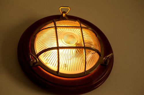 a light hanging on a wall in a room at Port in Izola