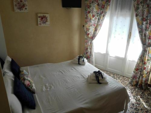 a bedroom with a white bed with two boxes on it at Affittacamere Da Carla in Bonassola