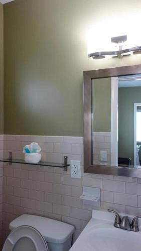 a bathroom with a sink and a toilet and a mirror at Ocean Drive Villas in Hollywood